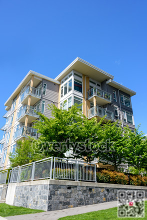 New low-rise residential building on blue sky background