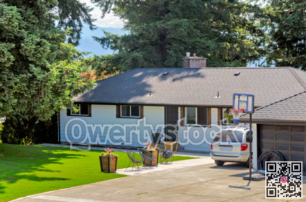 Average residential house with front yard lawn and car parked on the driveway