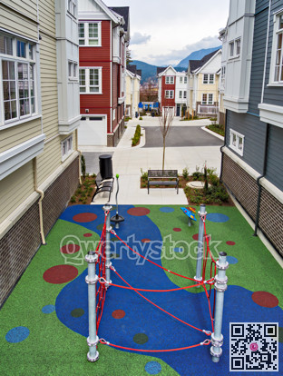 Playground space in residential area of townhouses on overcast sky background