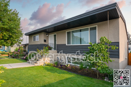 Average family house with concrete pathway over front yard