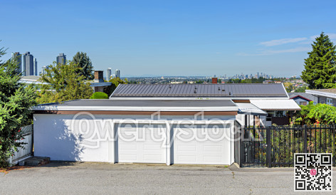 Double garage and backstreet entrance of family house with Vancouver downtown on the horizon