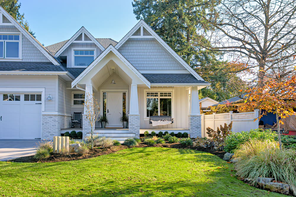 Residential house with open patio at the entrance doors under the porch