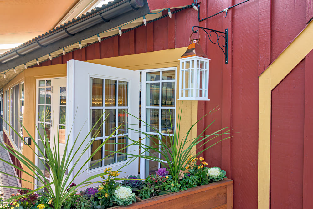 Entrance of a street cafe decorated with flowers