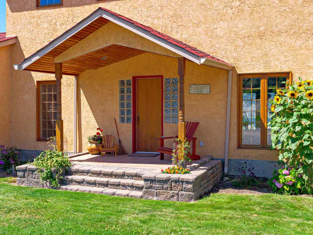 Entrance of a nice residential house with green lawn in front