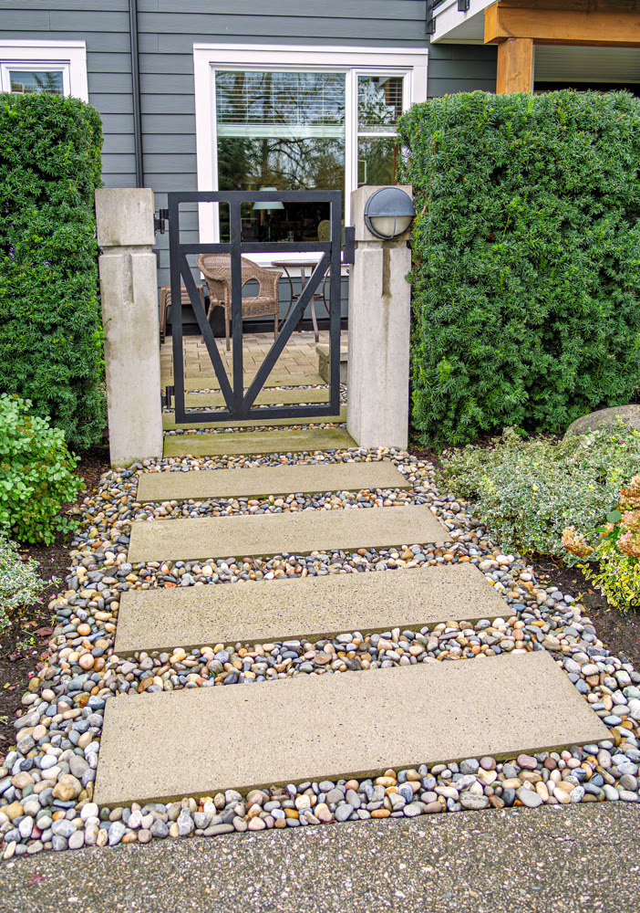 Ground level gated entrance of residential apartment on cloudy autumn day