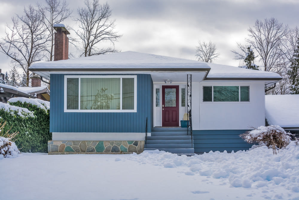 Family house with front yard in snow.