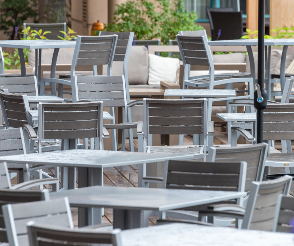 Vacant tables of a street cafe under the rain