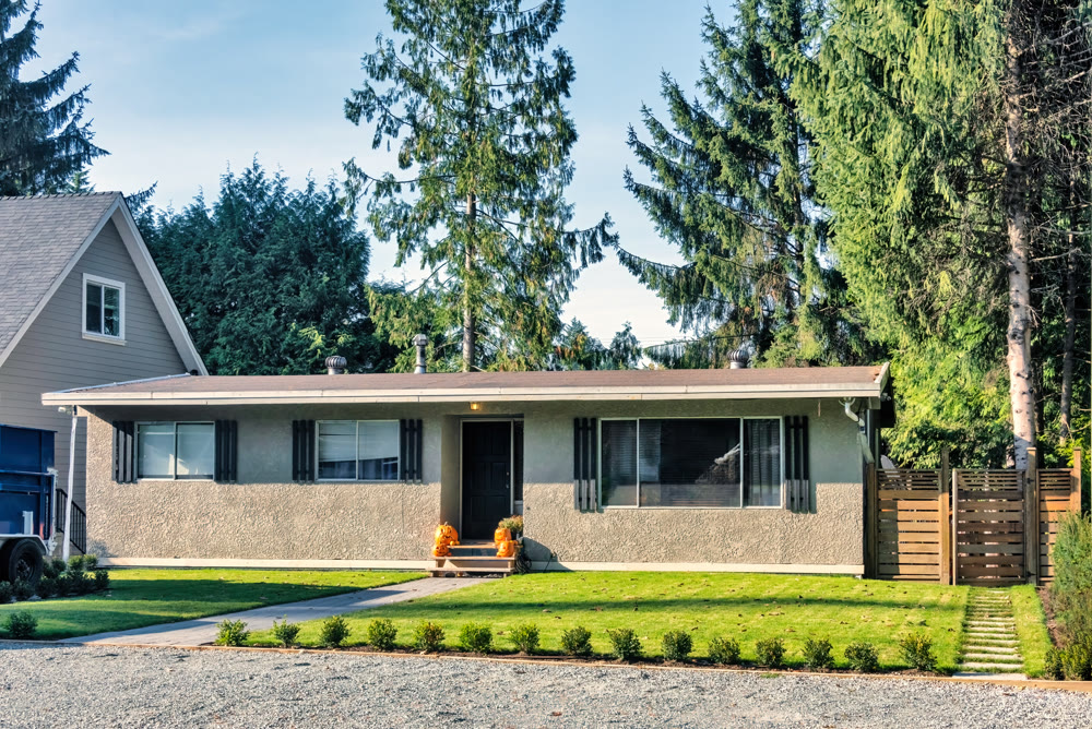 Modest residential house decorated with orange pumpkins