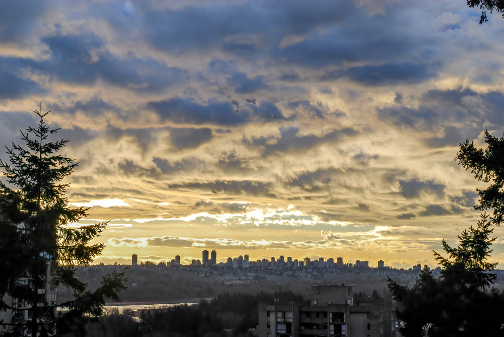 Big city landscape at sunset on cloudy sky background in Vancouver, Canada