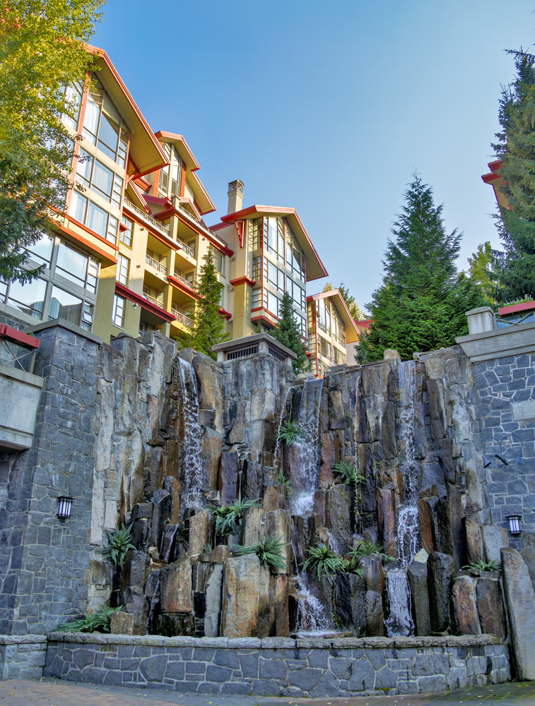 Residential block with decorative waterfall on sunset time in Whistler
