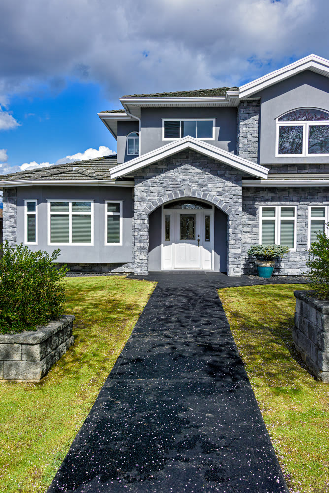 Nice residential house with stone texture walls and stone walls on front yard
