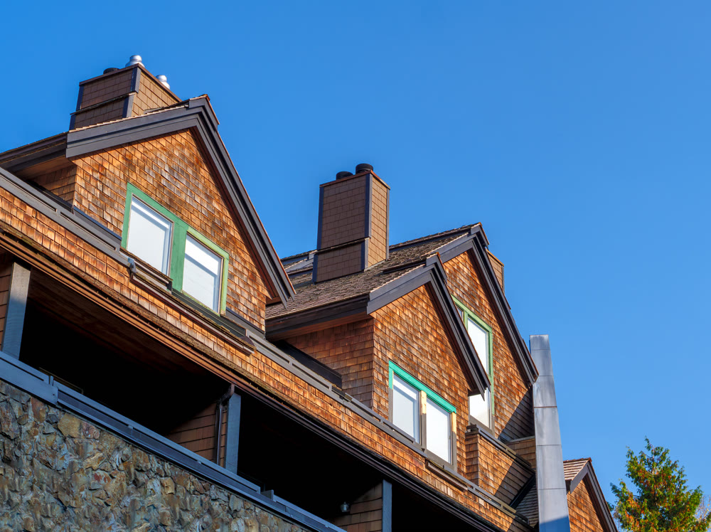 Residential condo with attic bedrooms on blue sky background