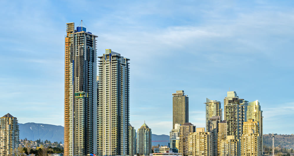 Settled and new high rise residential buildings on blue sky background