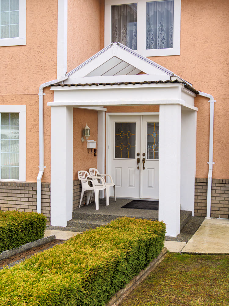 Entrance of residential house under transparent porch
