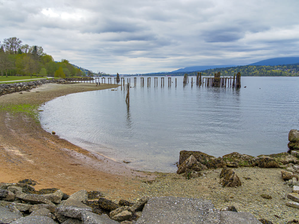 Round inlet and waterfront park with old wooden pier in the water