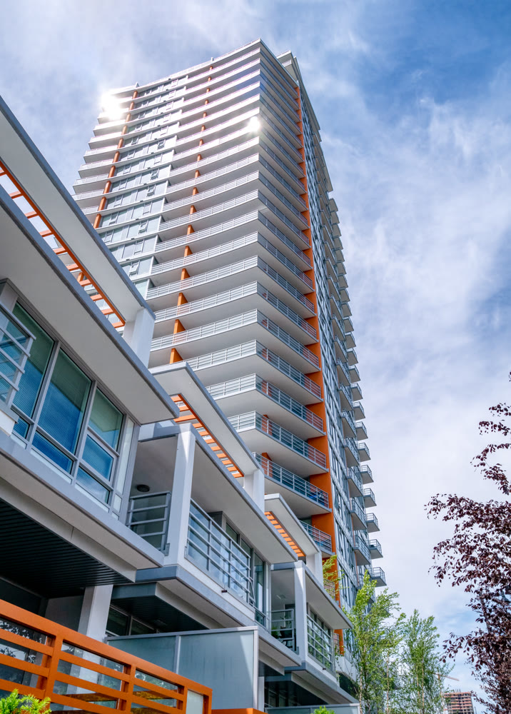 Brand new high-rise building on blue and white sky background