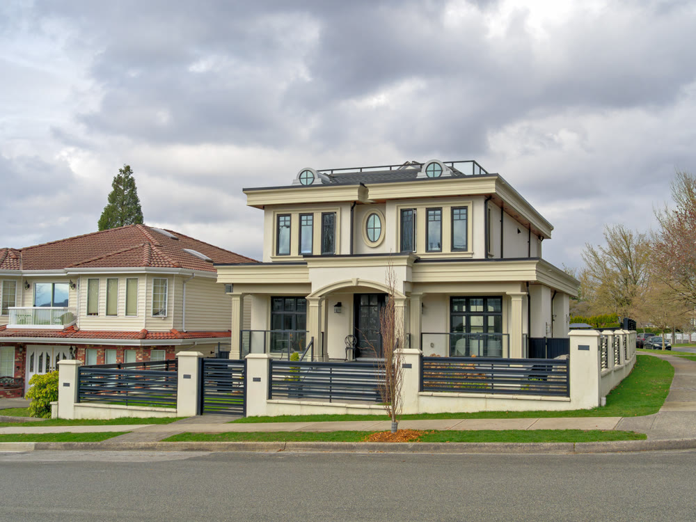 The street corner with residential houses on overcast sky background