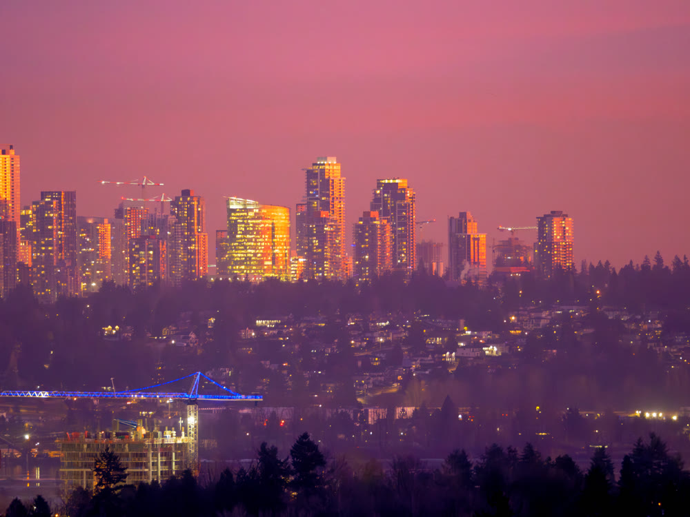 Unusual night city silouette highlighted with sunset rays in Surrey, BC
