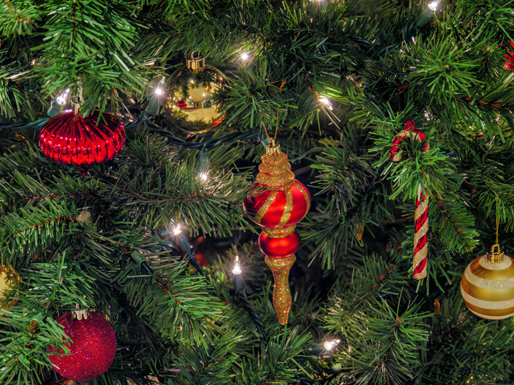 Halo of electtric lights and color balls decorating artificial Christmas tree