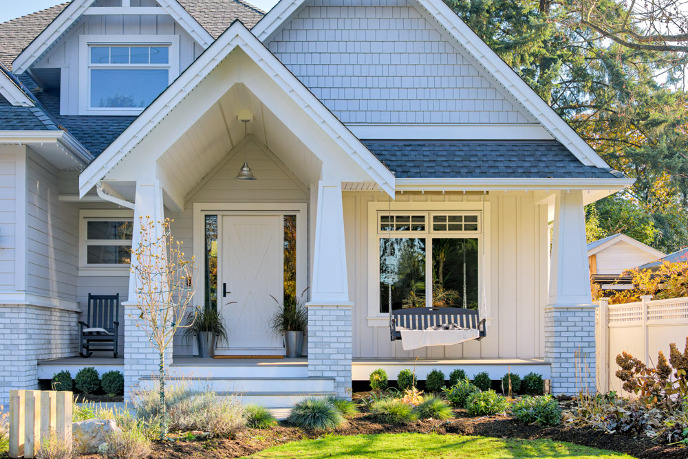 Residential house with open patio under the porch on sunny autumn day