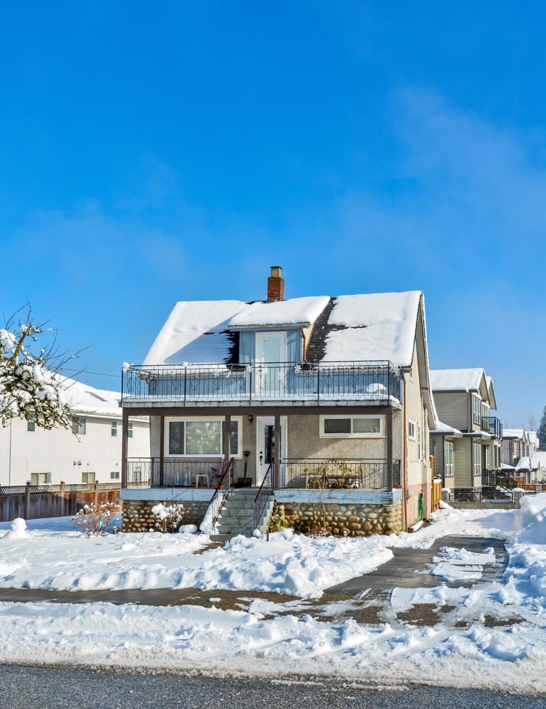Small old family residential house on sunny winter day in Canada