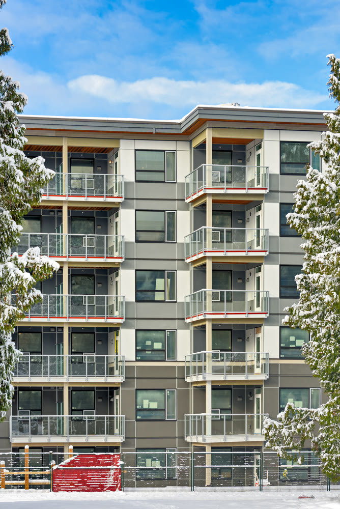 New low-rise residential building on finale stage of construction in winter