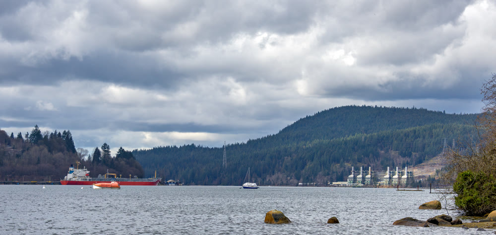 Overview of Pacific Ocean bay near Vancouver with production plant on the shore