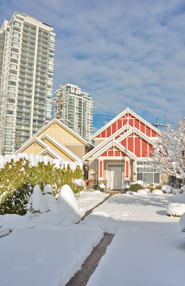 Modern high-rise and private residential houses in snow on winter season
