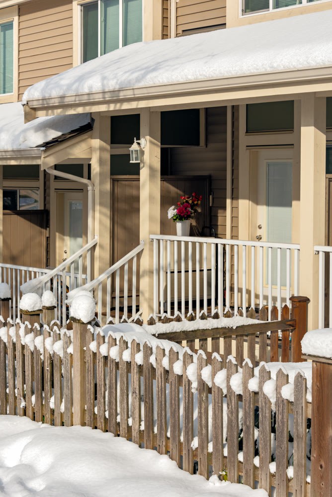 Small front yard, porch and entrance of residential townhouses on winter season in Canada