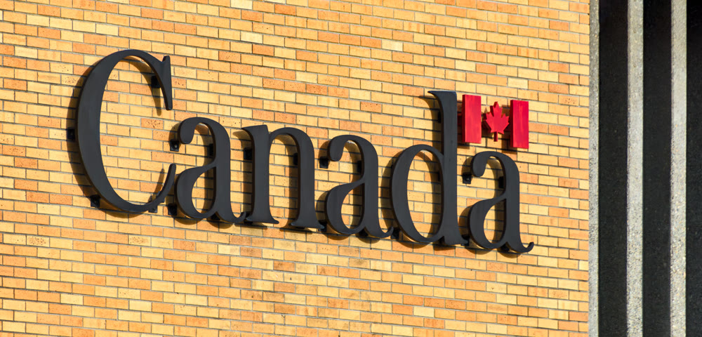 Canada. Name of the country on brick wall background