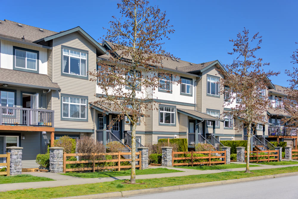 Street of residential townhouses on bright spring day in British Columbia, Canada