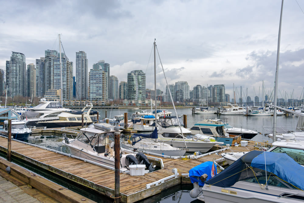 Yachts and boats moored at the pier in downtown of Vancouver, Canada