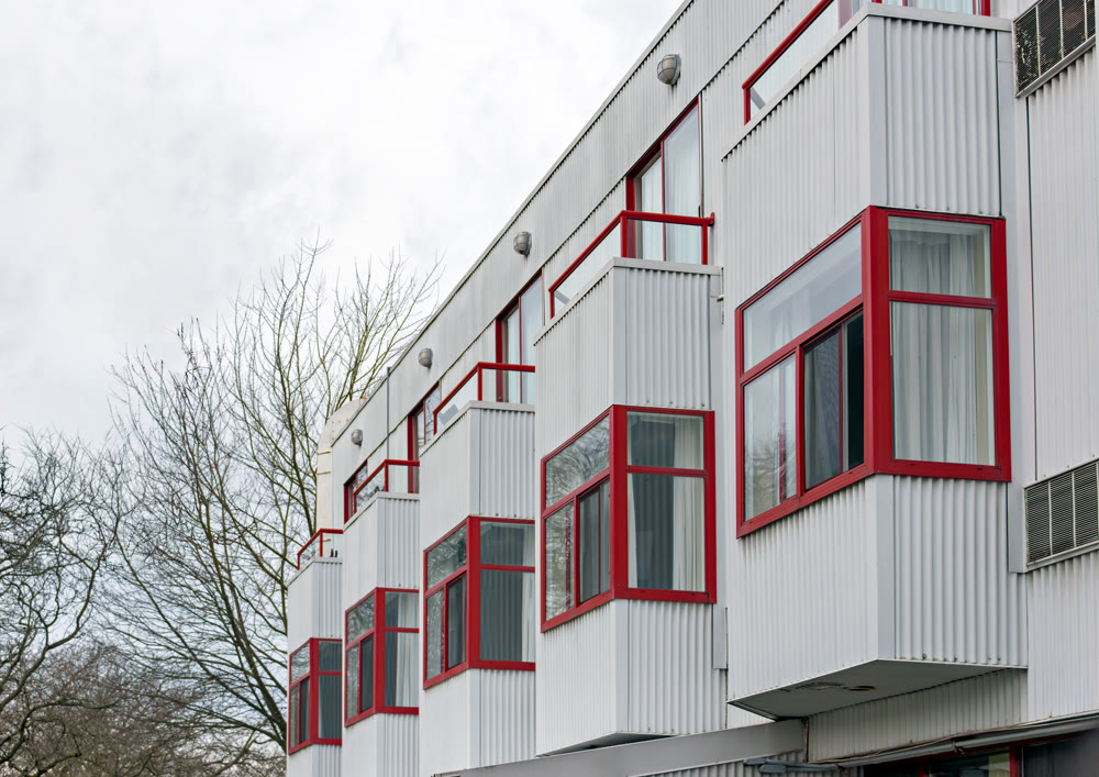 Goffer wall of residential building with erker windows in the row