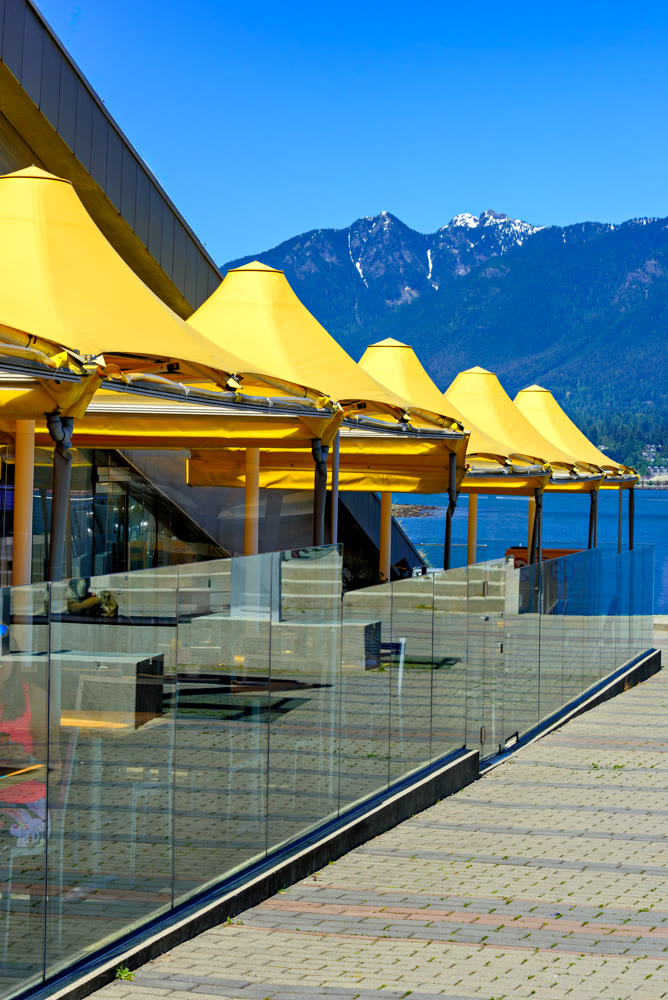 Yellow canopy of street cafe on waterfront in Vancouver