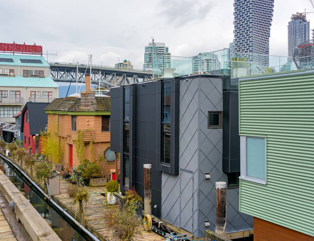 Row of houses on the water with view at downtown of Vancouver, Canada