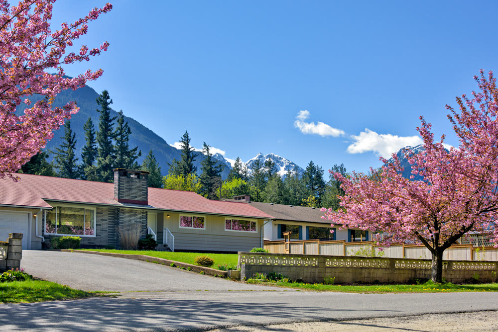 Family residential house on snow mountain and blue sky background