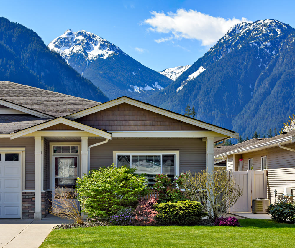 Family residential house on snow mountain and blue sky background