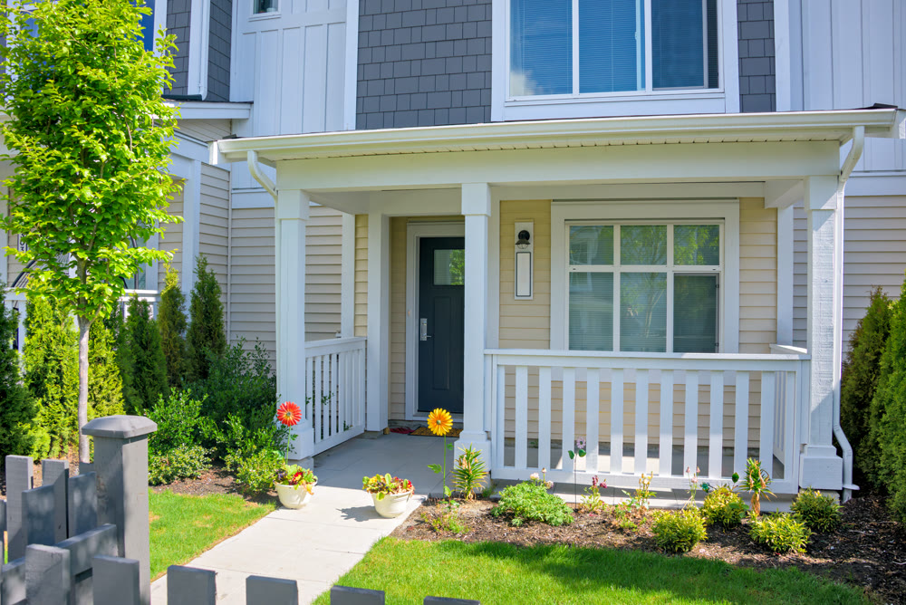 Residential house with open patio under the porch on sunny spring day