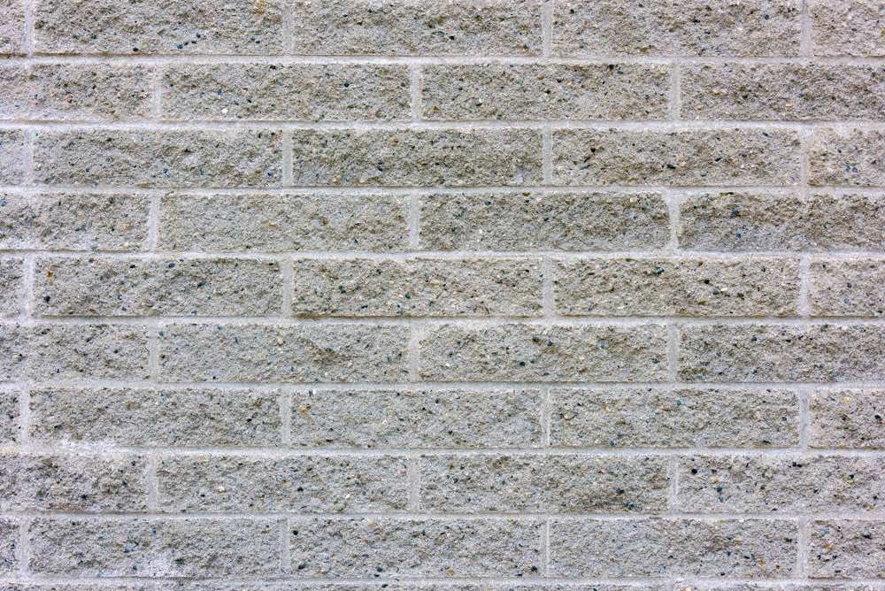 Concrete wall stylized under texture of silicate brick masonry