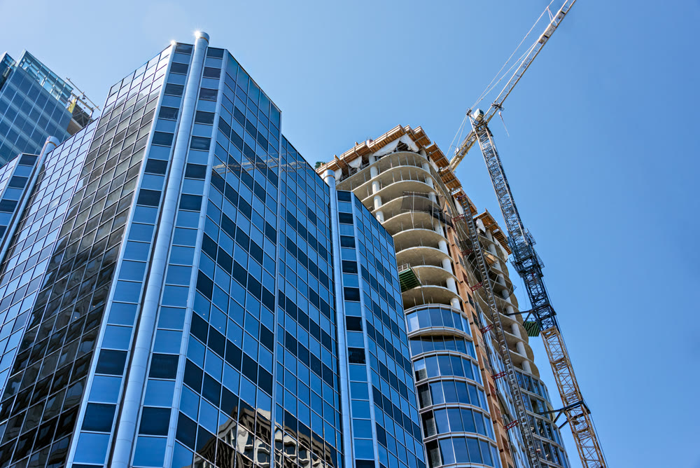 Monolite concrete building under constraction on blue sky background