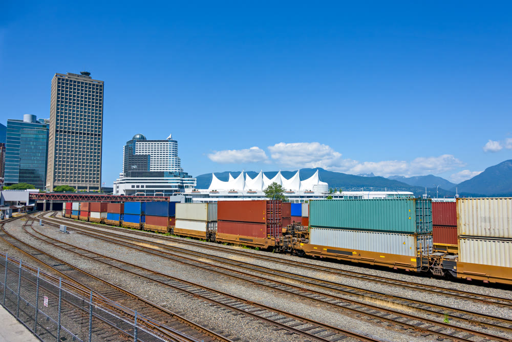 Container double cargo train going via downtown of Vancouver
