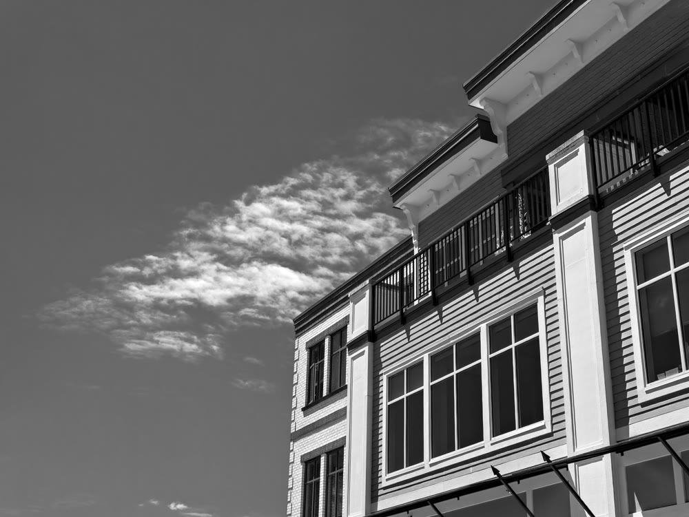 Top of residential building on cloudy sky background on a bright sunny day