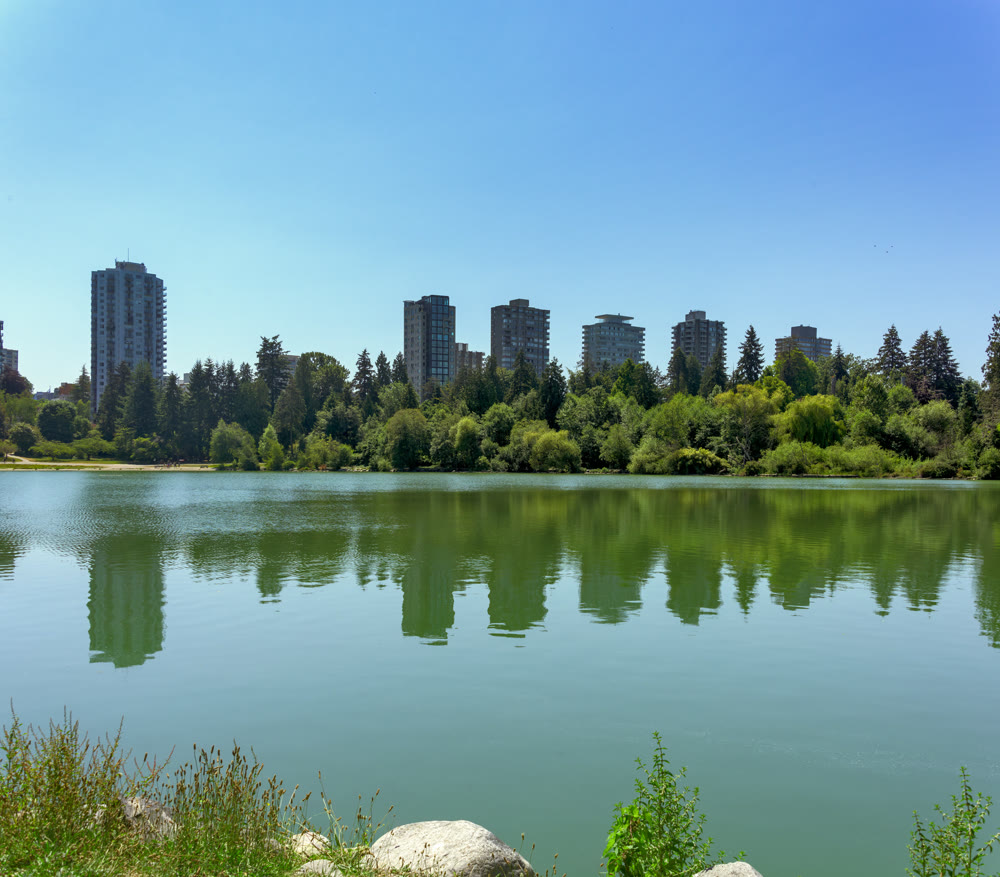 View over Lost Lagoon at old residential high-rises in downtown of Vancouver