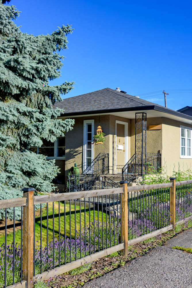 Entrance porch at the corner of residential house with light fence in front