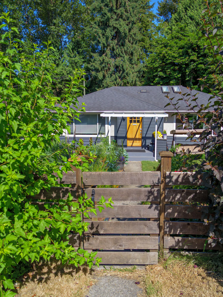 Perfect neighbourhood. Main entrance of family residential house with decorative flowers