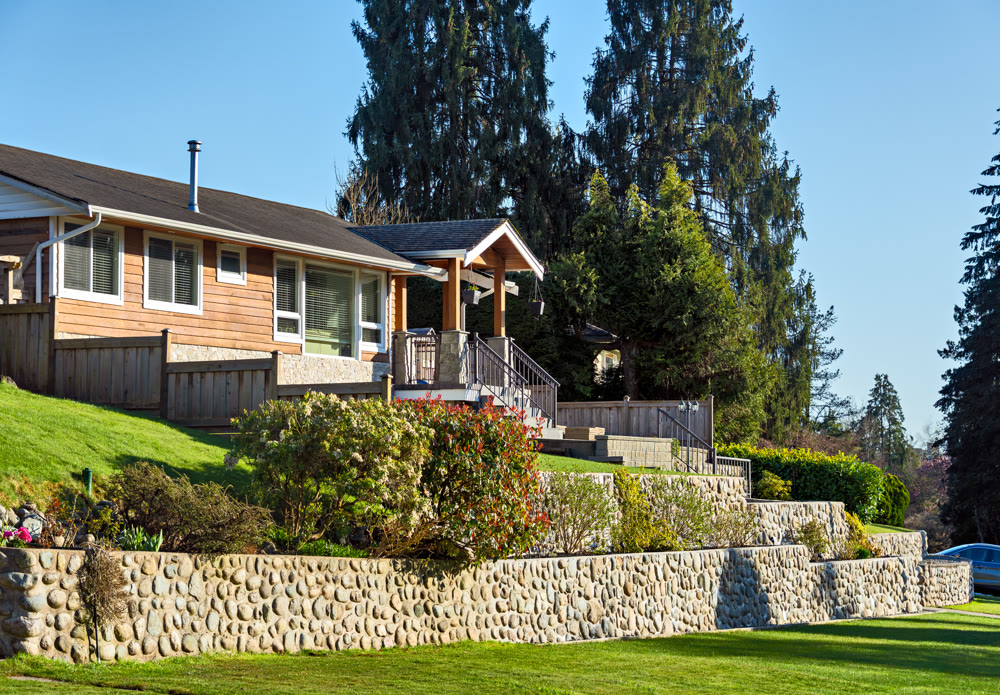 Family residential house on land terrace in sunset rays in British Columbia