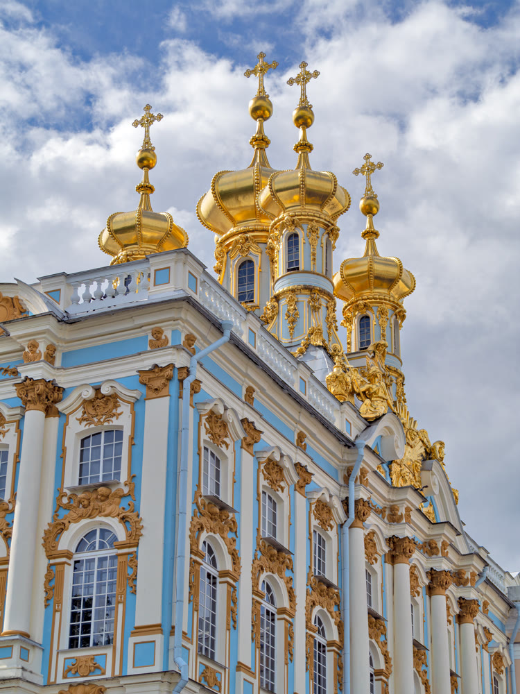 Golden domes against the background of clouds and blue sky
