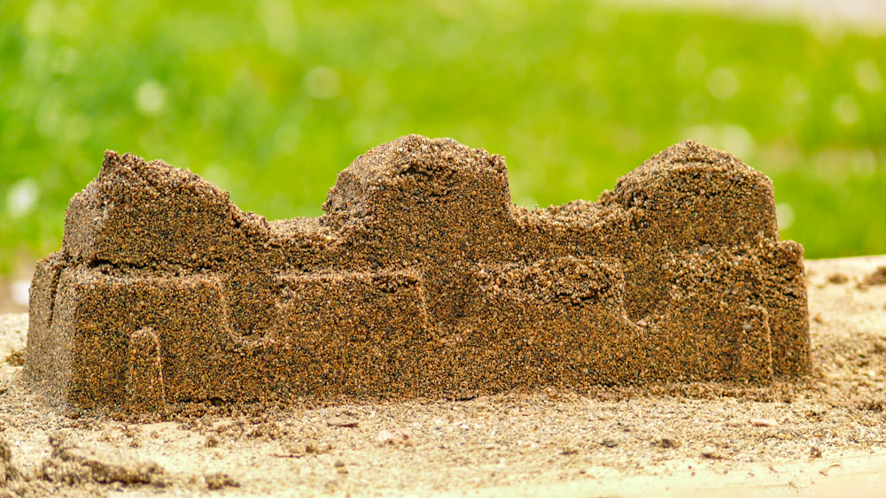Sand fortress wall created by kids in play