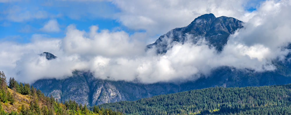 Mountain landscape view with clouds below the mountain's tops