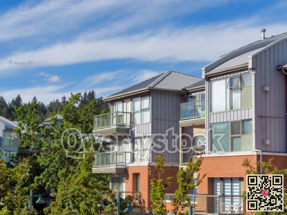 Top of residential low-rise building on cloudy sky background